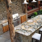 Outdoor granite kitchen with hand scribing around log beams