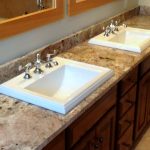 bathroom counter with two white drop-in sinks